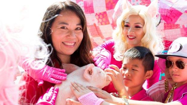 Valerie Khoo, curator of the Sydney Lunar Festival for the Lunar New Year with the Roving Pigs dancers from Dance Kool.