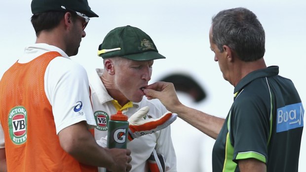 Brad Haddin is tended to by team doctor Peter Brukner on day two of the second Test.