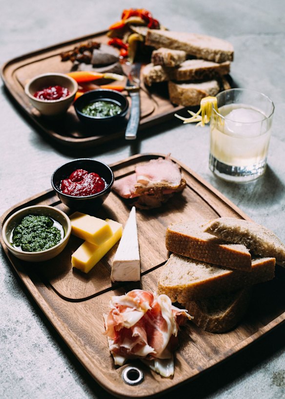 Platters of meats, cheeses and fruit, roots and seeds.