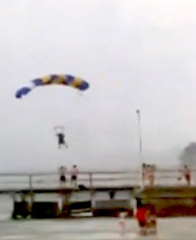Sky divers on descent before being rescued after wild storms hit St Kilda on Wednesday.