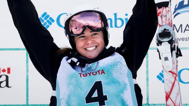 Stepping stone: Britt Cox celebrates her victory in the women's World Cup freestyle moguls event in Calgary, Alberta.