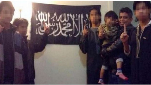 A photo Zulfikar Shariff posted on his Facebook page of himself with his children in front of a flag associated with the Islamist group Hizb ut-Tahrir.