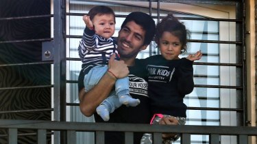 All smiles: Luis Suarez greets fans at the home of his mother in Uruguay.