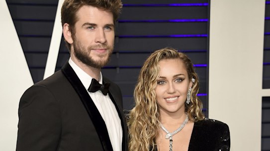 Liam Hemsworth, left, and Miley Cyrus arrive at the Vanity Fair Oscar Party.