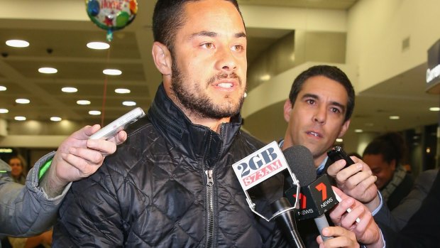 Scrum time: Jarryd Hayne is questioned by waiting media upon arrival at Sydney Airport.