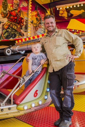 The Royal Canberra Show will be open on Friday. Elwin Bell of Bells Amusements with his grandson Boston Brophy 22-months-old.
