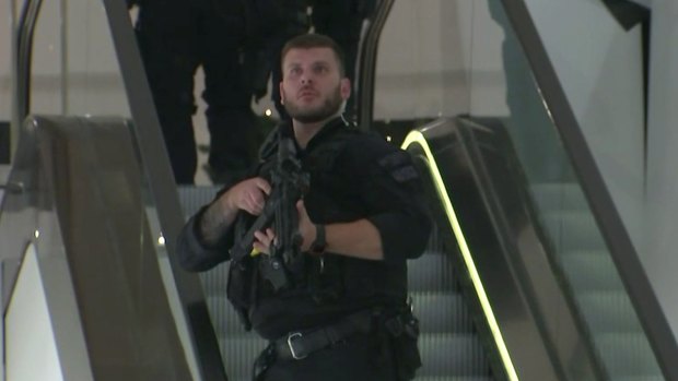 An armed police officer patrols a department store near to Oxford Street in London on Friday night.
