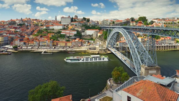 The Scenic Azure passes under the Dom Luis I Bridge in Porto.