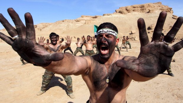 Shiite fighters who have joined the Iraqi army to fight against Islamic State militants take part in field training in the desert in Najaf, south of Baghdad.