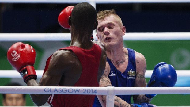 Daniel Lewis (R) of Australia won his bout against Kehinde Ademuyiwa of Nigeria, but a cut eye puts a cloud over his campaign.