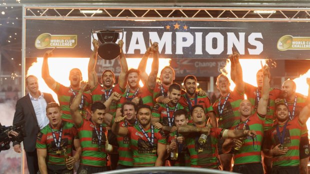 Champions: Captain Greg Inglis lifts the trophy in celebration after the South Sydney Rabbitohs beat St Helens to win the World Club Challenge.