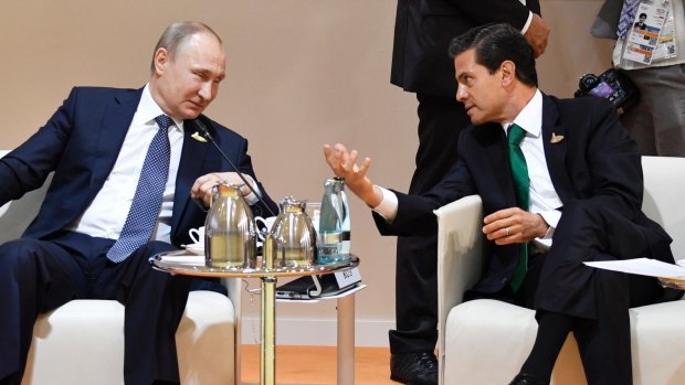 Russia's President Vladimir Putin, left, and Mexico's President Enrique Pena Nieto talk at the G-20 summit in Hamburg in July.