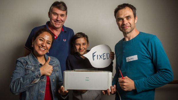 Thank you: Customers, from left, Konika, Peter and Krishan Sadler pose with electrician James Enright, right, who fixed their toaster at Melbourne Repair Cafe in Yarraville.