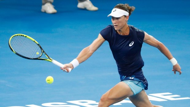 Stretch: Stosur reaches for a shot in a rally with Anastasija Sevastova of Latvia in their first-round match at the Brisbane International.