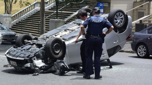 A car has flipped onto its roof in Brisbane's CBD.