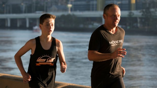 Mr Biszczak finishing the final five kilometres of his Million Dollar Run with EB sufferer Lachlan Woodward at South Bank.