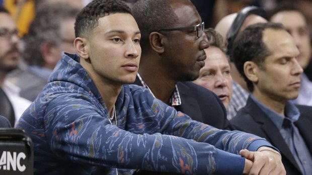 LSU's Ben Simmons sits court side in the first half of an NBA game between the Milwaukee Bucks and the Cleveland Cavaliers.