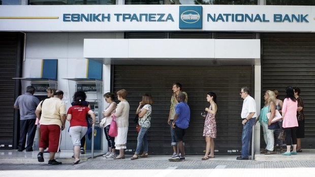 Greeks queue in front of the National Bank to use ATM.