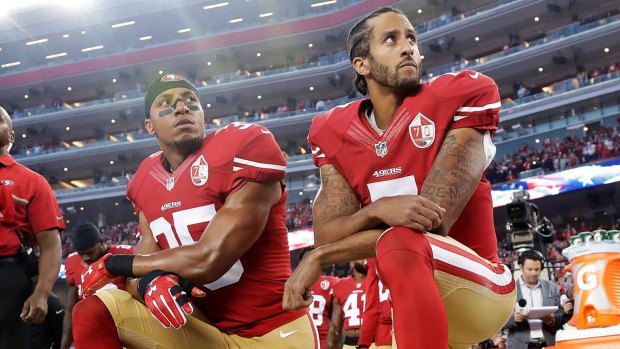 San Francisco 49er Eric Reid (left) joins then teammate Colin Kaepernick in kneeling during the national anthem last season, a demonstration that has polarised public opinion.