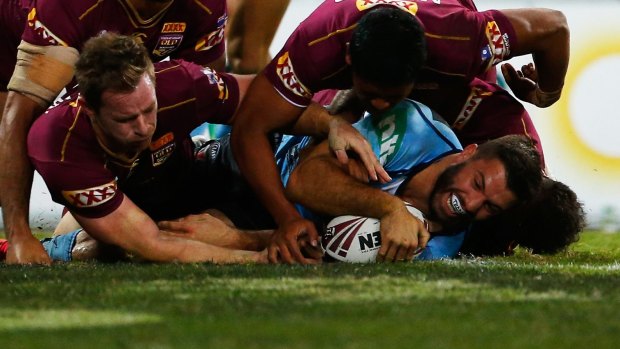 Teddy time: James Tedesco of the Blues scores against Queensland at Suncorp Stadium on Wednesday night.