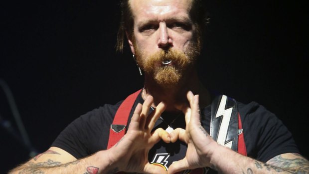 Jesse Hughes, frontman of California rock band Eagles of Death Metal, makes a heart sign as the band performs at the Olympia Concert Hall in Paris on Tuesday.