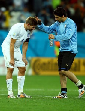 Suarez consoles his Liverpool teammate Steven Gerrard.