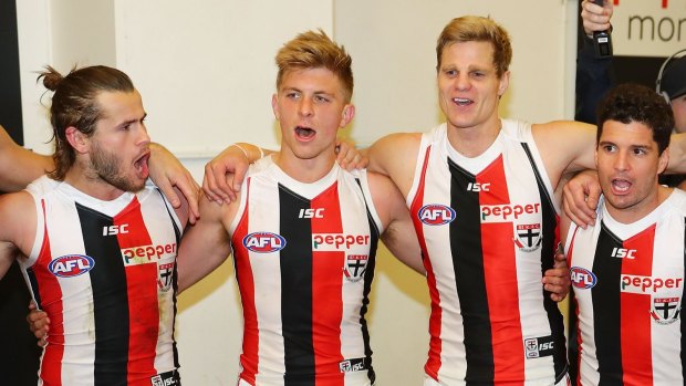 Saints Josh Bruce, Luke Dunstan Nick Riewoldt and Leigh Montagna belt out the song after their win against Carlton on Sunday. 