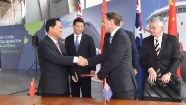 Liu Cigui of China's State Oceanic Administration and Environment Minister Greg Hunt shake hands after signing a Memorandum of Understanding on Antarctic collaboration. 