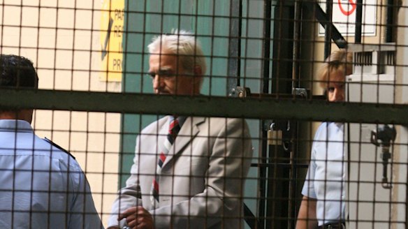 Dragan Vasiljkovic aka Daniel Sneddon, known as Captain Dragan is led by corrective services guards into the van at Central Local Court in Perth in 2007