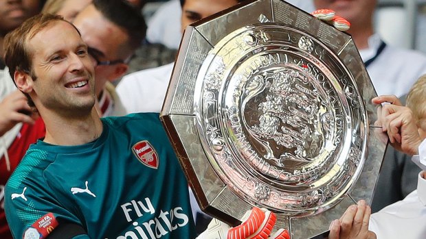 Arsenal's goalkeeper Petr Cech and manager Arsene Wenger hold the  Community Shield trophy at Wembley on Sunday.