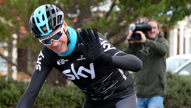 Four-time Tour de France champion Chris Froome waves while training in Spain.