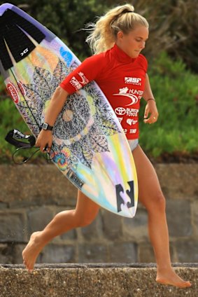 Felicity Palmateer leaps on to the beach in Newcastle during Surfest 2014. 