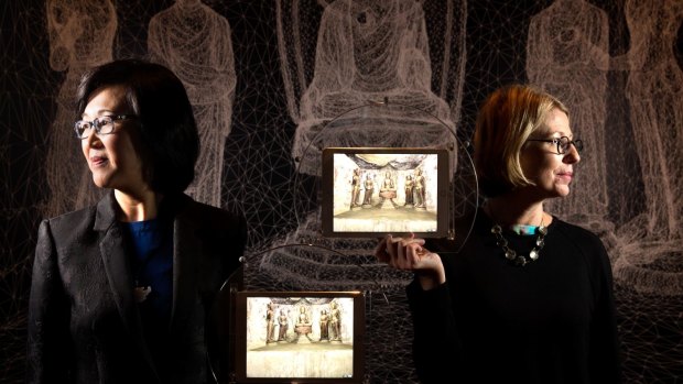 Yin Cao and Professor Sarah Kenderine with interactive iPads that bring one of the exhibits for Tang: Treasures from the Silk Road Capital, alive at the Art Gallery of NSW.