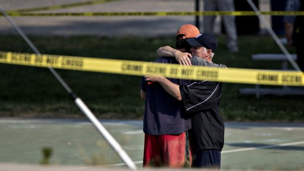 Two people hug in front of police tape following a shooting during a congressional baseball practice near the Eugene Simpson Stadium Park in Virginia on Wednesday. 