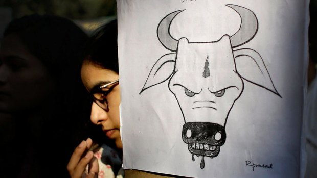 In this file photo, a student activist holds a placard during a protest denouncing the killing of a Muslim farmer by villagers upon hearing rumors that the family was eating beef.