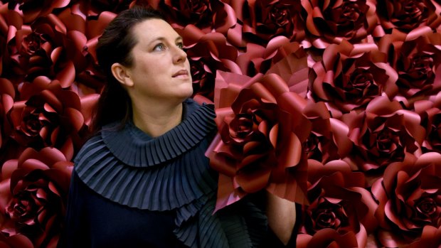 Acclaimed UK paper artist, Zoe Bradley, creating a new work at Chatswood Chase titled Red Rose Dress using 400 hand sculptured paper roses.