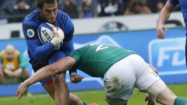 Lined up: France's Maxime Medard, left is tackled by Rory Best.