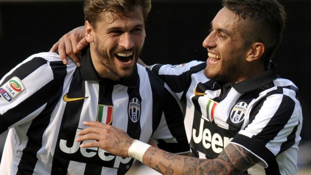 Juventus' Roberto Pereyra, right, celebrates with his teammate Fernando Llorente after scoring against Verona.
