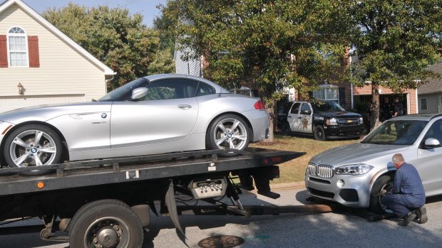 Cars belonging to suspect Todd Kohlhepp are taken away.
