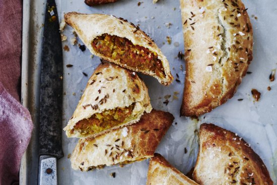 Spiced lentil and vegetable pasties sprinkled with cumin seeds.