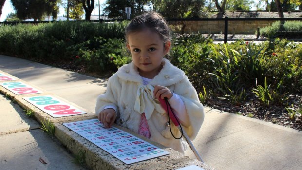 Mia Wilkes loves using the new Braille signs.
