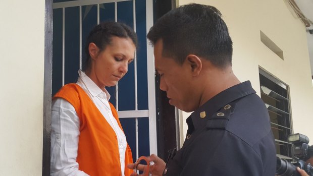 Byron Bay woman Sara Connor is handcuffed for the transfer from her holding cell to the Denpasar District Court.