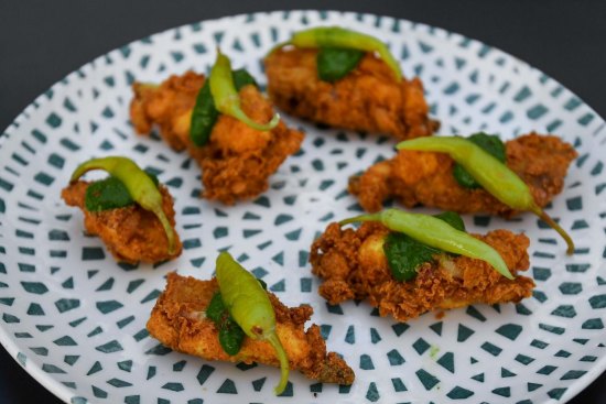 Deep-fried chicken ribs with chimichurri and guindilla peppers.