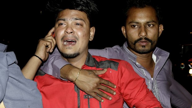 A man at the scene of Sunday's bomb blast in Lahore waits for news of relatives.