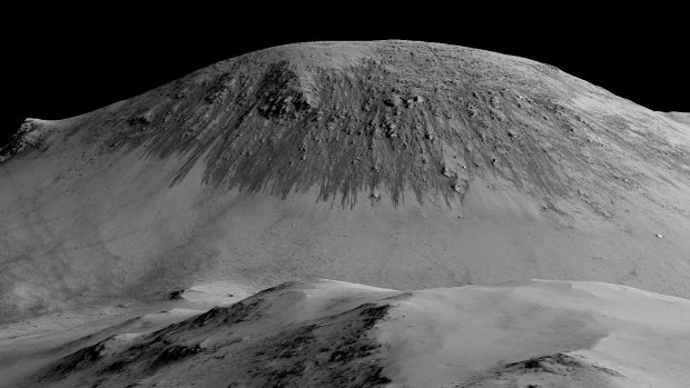 A view of what are believed to be streaks caused by water that once flowed downhill on Mars. 
