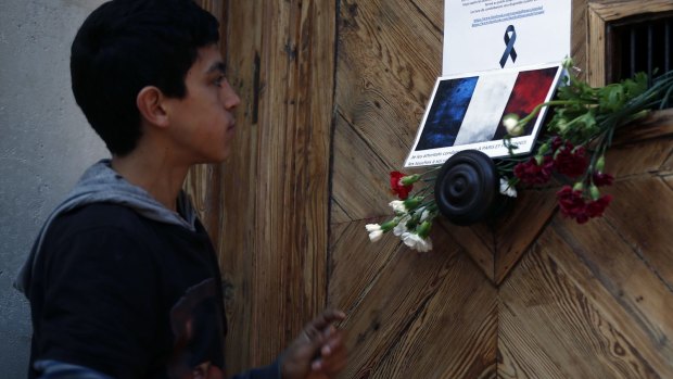A young man reads a notice informing him about the closure of the French consulate in Istanbul to mark three days of mourning after the Paris attacks.