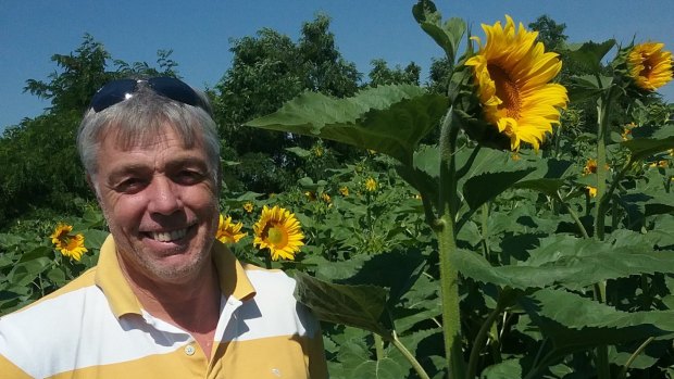 Ballarat man Lawrence Richmond in a sunflower crop growing on a farm in Ukraine.