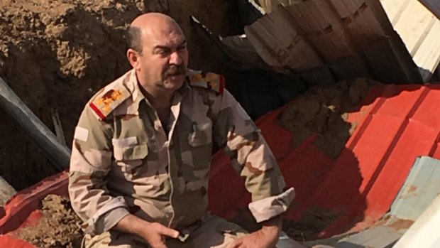 Iraqi Brigadier-General Hassan al-Nuaimi in a trench on the road to Mosul.