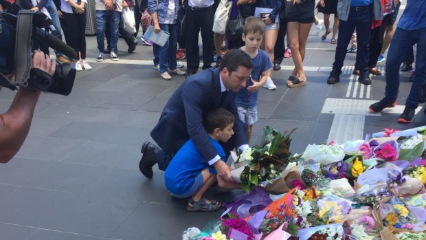 Opposition leader Matthew Guy pays his respects at the makeshift shrine in Bourke Street Mall.