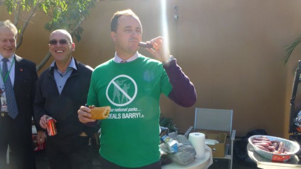 NSW Greens MP Jeremy Buckingham eats a "freshly-hunted" sausage at a barbecue in 2013.